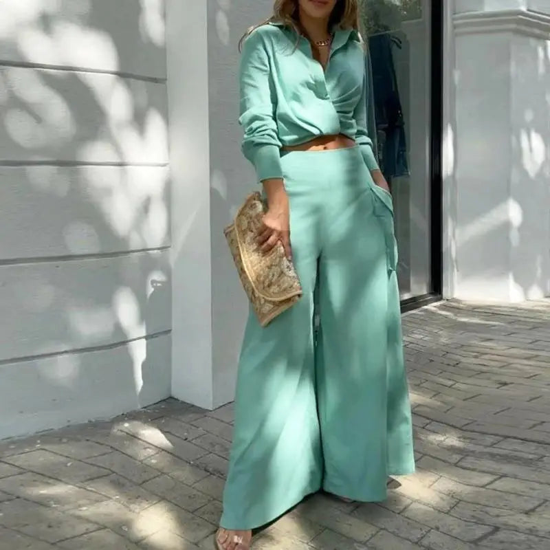 Women's formal outfit with cropped shirt and tailored wide-leg trousers
