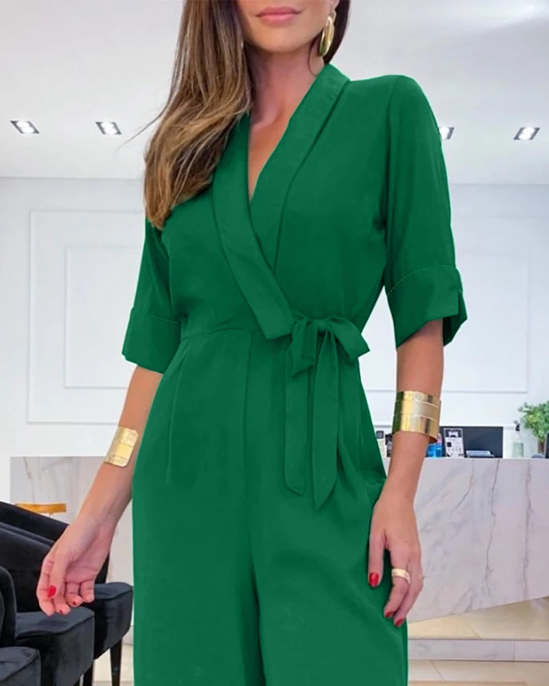 Elegant women's jumpsuit with a V-neck, 3/4 sleeves, defined waist, and wide legs