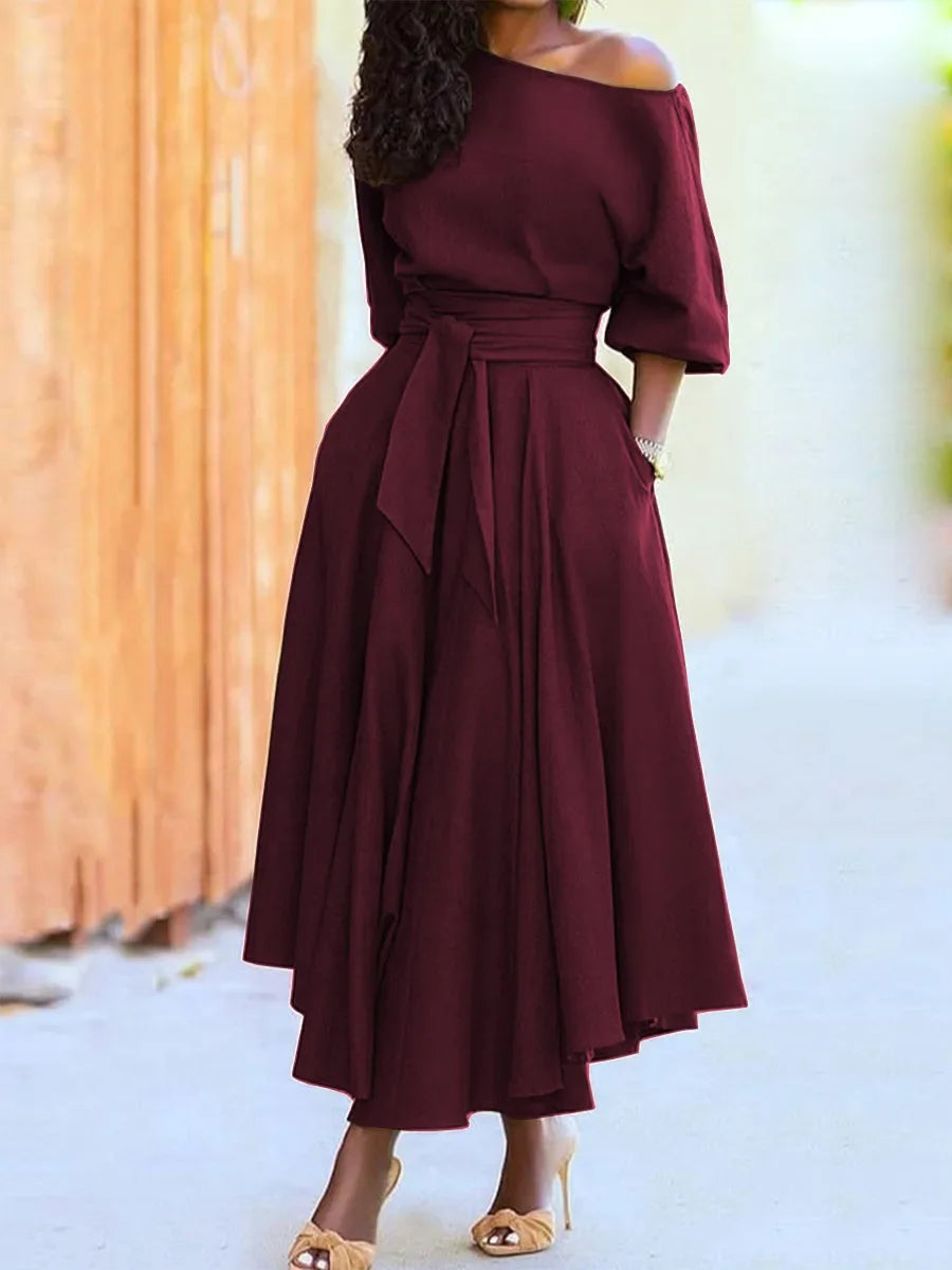 Elegant women's off-the-shoulder midi dress with a flared silhouette, defined waist, and pockets
