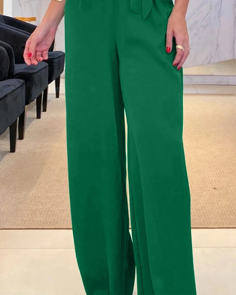 Elegant women's jumpsuit with a V-neck, 3/4 sleeves, defined waist, and wide legs